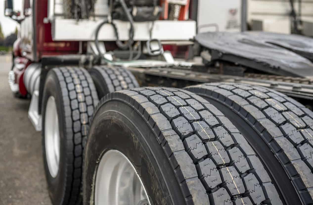 Wheels with tires on axels of big rig semi truck standing on parking lot Balancing Beads near me