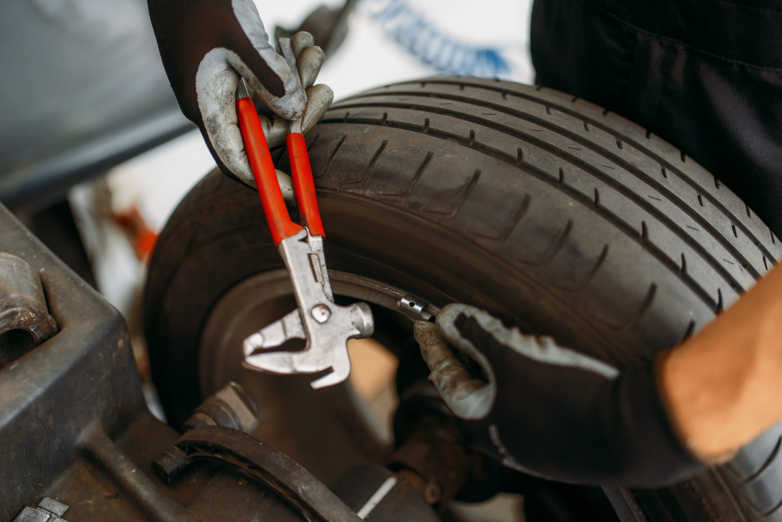 Auto mechanic balancing wheel, tire service